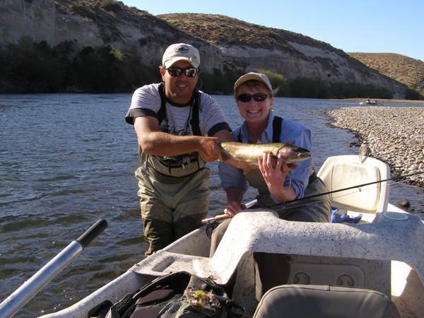 Jackie Berger and her guide with a Collon Cura rainbow trout